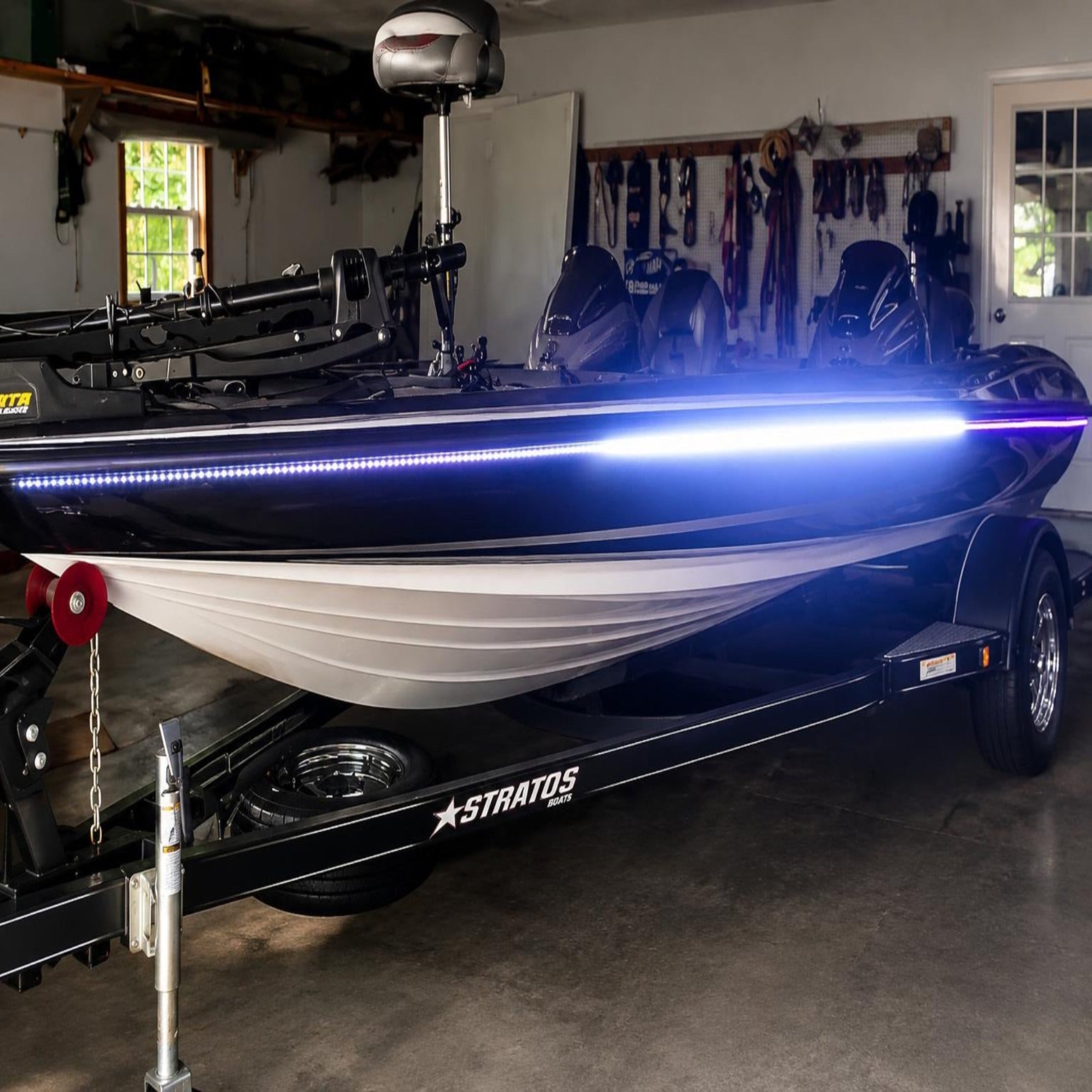 Boat on a trailer with LED lights in a garage